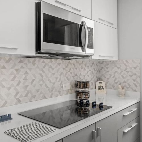 Your convenient culinary corner! This bright kitchenette area features a microwave and ample counter space, perfect for preparing quick meals or snacks during your stay.