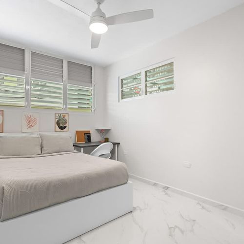 Stylish bedding, modern art, and a great space to relax.