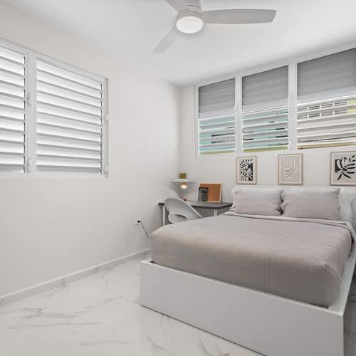 Lush, clean queen bed. Minimalist art creates a serene escape.