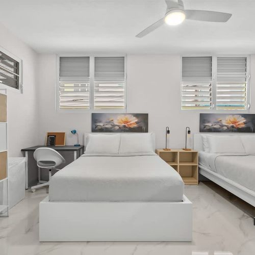 Spotless bedroom with modern shelving and plush bed.