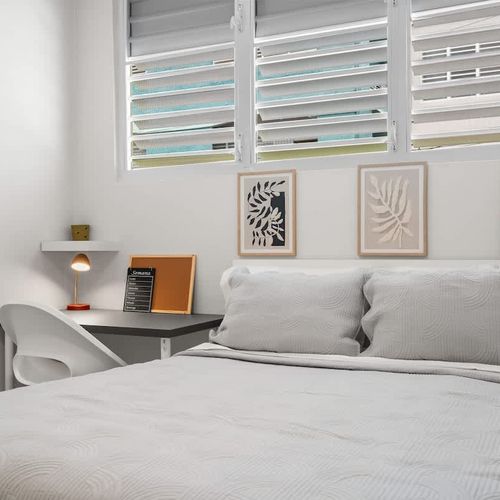 Spotless bedroom with modern shelving and plush bed.