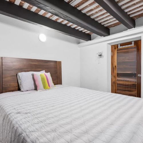 Restful sleep: Comfortable bed with a striking wooden headboard.