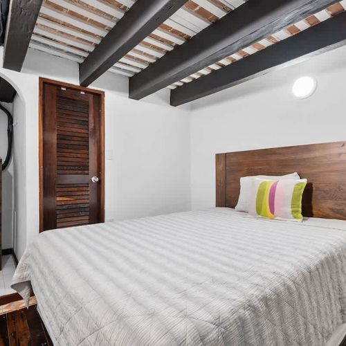 Artistic sleep: Cozy bedroom featuring curated, vibrant local art.