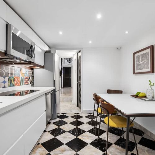Minimalist cooking: Clean, white lower cabinets and simple design.