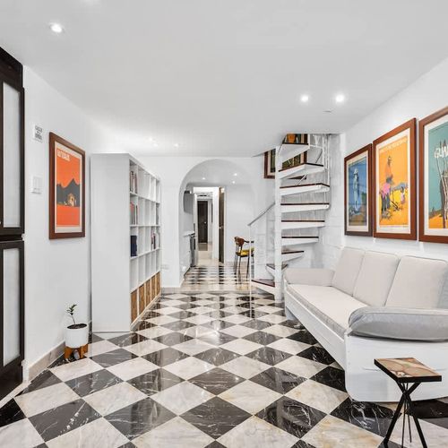 Art gallery feel: Unique checkerboard floors & vibrant stairwell.