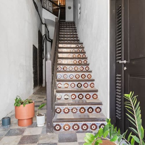 Upward style: Artistic stairs complemented by simple potted greenery.