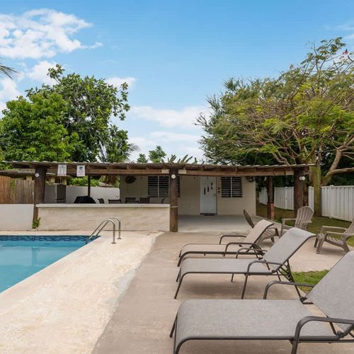 Ample lounge chairs for tanning poolside.