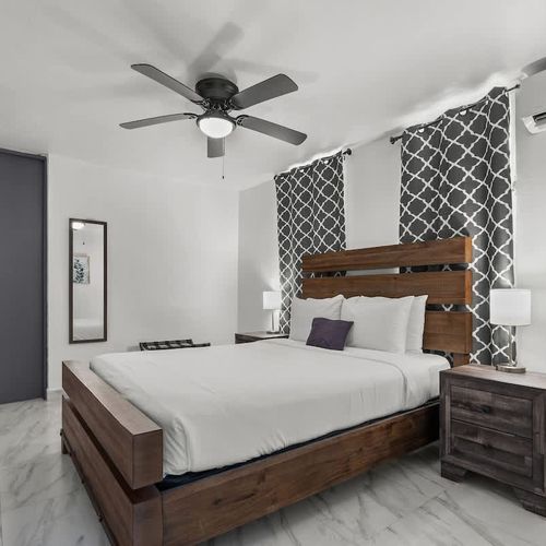 Warm, inviting primary bedroom with AC. Rest well!