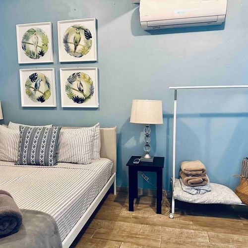 Comfort meets convenience: This image highlights the serene ambiance of our principal bedroom, featuring a generous queen bed and the added comfort of air conditioning.