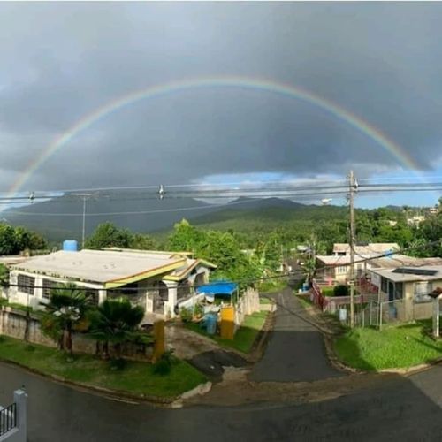 Experience magical moments! This stunning view captures the vibrant local landscape, often graced by beautiful rainbows, promising an unforgettable backdrop to your stay."