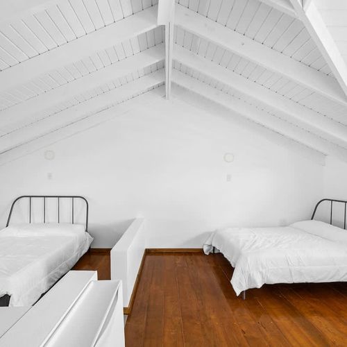 This bright and clean bedroom features twin beds, perfect for a restful night's sleep.