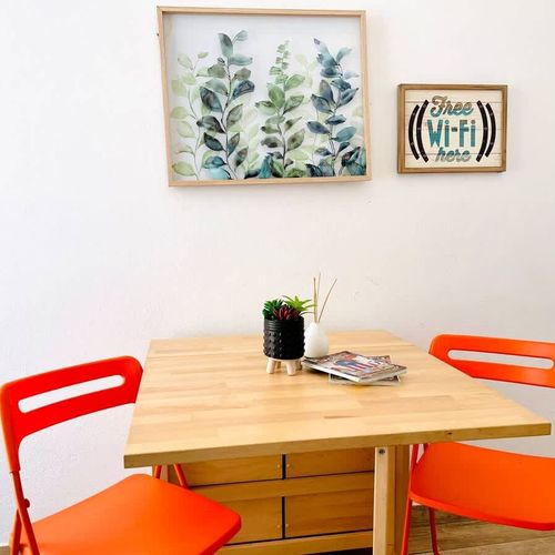 Gather around our welcoming dining table, adorned with captivating wall art – the perfect spot for memorable meals, lively conversations, and planning your next adventure.