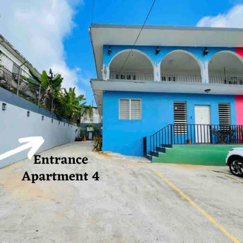 Step into your inviting retreat! Our vibrant house entrance leads directly to your private Apartment 4, promising a warm welcome to your Caribbean escape.
