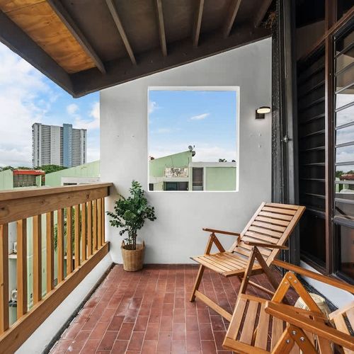 Relish the peaceful environment from this inviting balcony, offering a glimpse of the marina through a picturesque window-like opening.