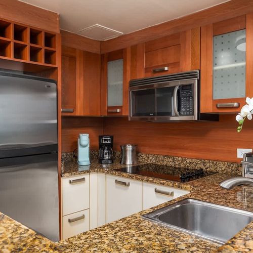Convenience at your fingertips! This well-appointed kitchenette features a fridge, stove, microwave, and more.