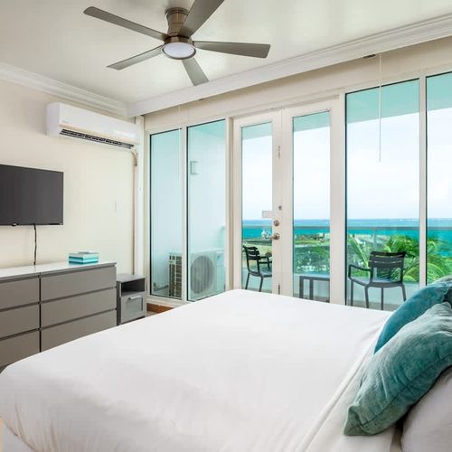 Wake up to paradise! Your luxurious King bed faces stunning ocean views, with direct access to your private balcony.