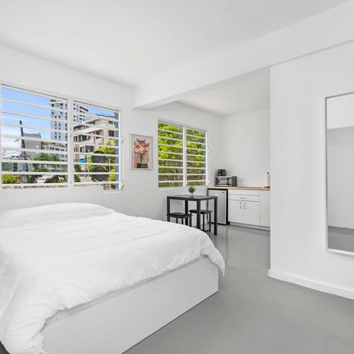 The large window invites natural light, and the air conditioner ensures a pleasant stay. Unwind in comfort with a spacious bed, sleek design, and contemporary style awaiting you.