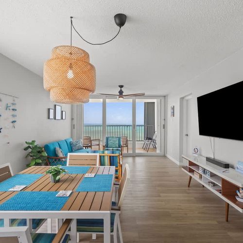 Open concept living with a view! This bright and airy space seamlessly connects the comfortable living area with the dining space, leading directly to a private balcony with stunning outdoor vistas.