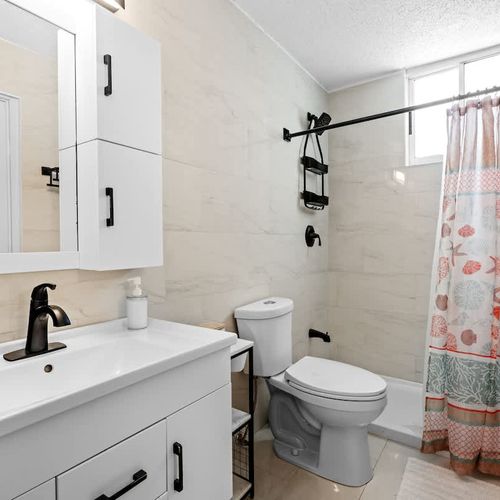 Sparkling clean and modern! Our private bathroom features a sleek vanity, ample lighting, and a fresh design, ensuring a comfortable and hygienic experience.