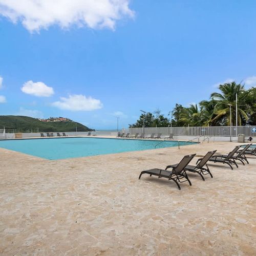 Dive into refreshment! Our sparkling communal pool invites you to cool off and relax under the Caribbean sun, surrounded by lush tropical landscaping.