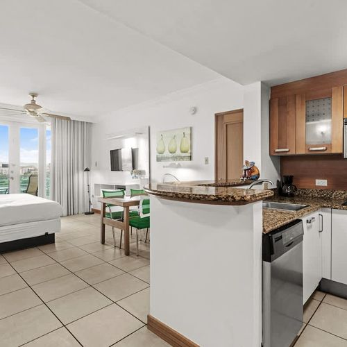 Experience the best of open-concept living in this inviting studio. From the fully equipped kitchenette and comfortable bed to the dining area and stunning balcony views, every element is curated for a delightful and memorable stay.