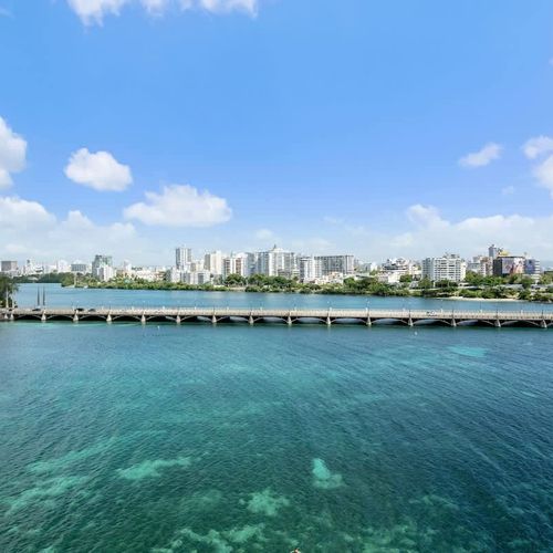 Behold the magnificent Condado Lagoon, a vibrant centerpiece of our locale. This panoramic view showcases the serene waters, lush surroundings, and the iconic bridge, inviting you to explore the beauty of San Juan from above.