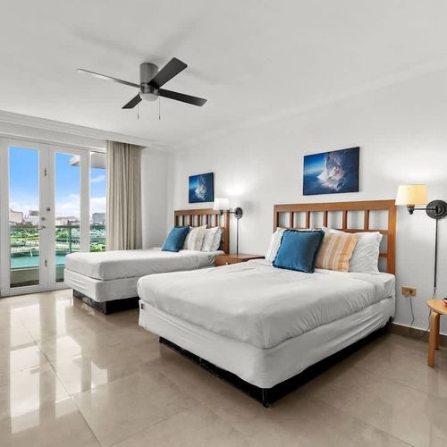 Wake up to stunning views from your private balcony in this charming bedroom featuring two cozy twin beds. Enjoy the natural light and fresh air, making it an ideal retreat after a day of exploration.