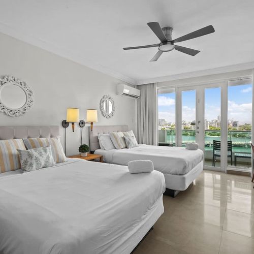 Accommodate everyone comfortably in our spacious bedroom with two individual beds. Designed for both relaxation and convenience, this room offers a peaceful haven with easy access to outdoor views, perfect for sharing memories