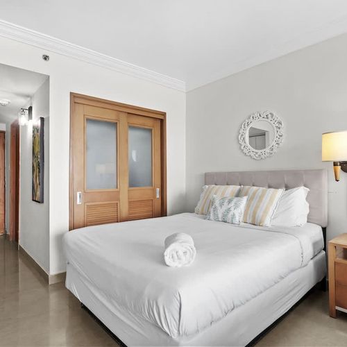 Settle into ultimate comfort in this inviting bedroom featuring a plush queen-sized bed. With ample storage in the stylish sliding door wardrobe, you'll feel right at home and ready to relax after a day of exploring.