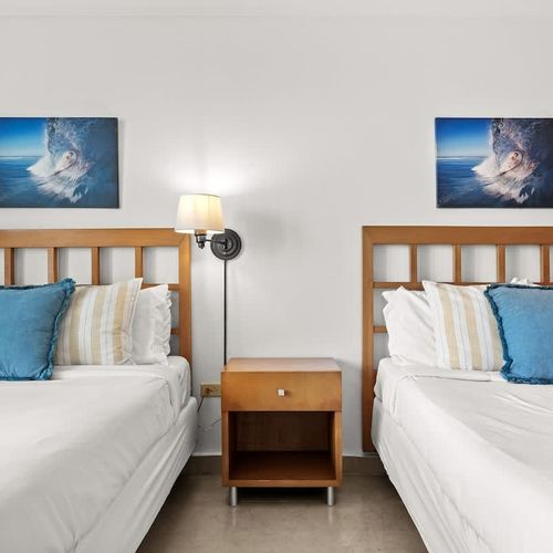 Drift off to sleep in one of two comfortable beds in this bright and airy room. With ample space and a tranquil ambiance, it's perfect for families or friends traveling together, ensuring a restful night for everyone