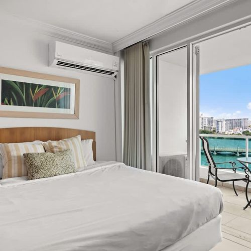 Step onto your private balcony directly from this inviting bedroom and immerse yourself in the vibrant beauty of the lagoon. Perfect for enjoying your morning coffee or simply soaking in the incredible waterfront scenery.