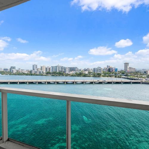This breathtaking aerial perspective captures the essence of San Juan's coastal charm, from the calm lagoon waters to the distant ocean and the bustling cityscape. Experience the vibrant interplay of nature and urban life right from your window.