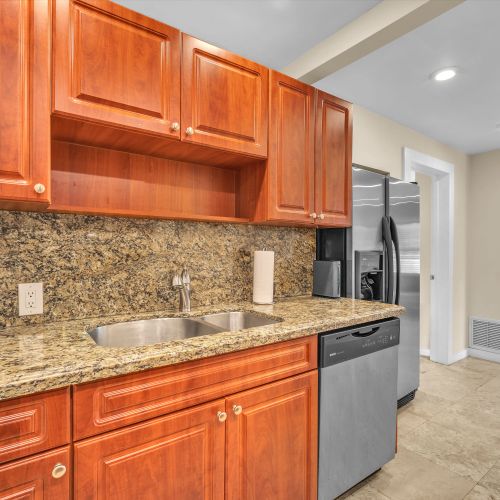 Spotless, generously-sized, and equipped kitchen with ample storage, ensuring a seamless cooking experience.