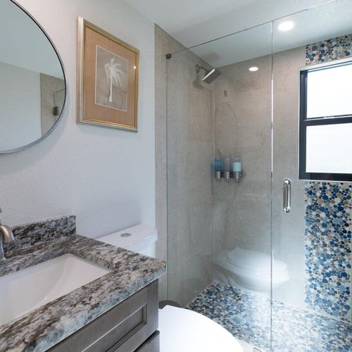 This bright and sleek bathroom offers a large, walk-in shower to refresh after a good night's sleep. If you're coming from the beach there's an outdoor shower to wash off the sand!