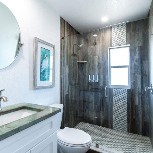 This bright and sleek bathroom offers a large, walk-in shower to refresh after a good night's sleep. If you're coming from the beach there's an outdoor shower to wash off the sand!