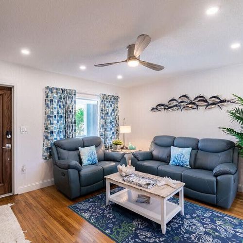 The living room is meant to help you relax and get out of the sun, complete with a ceiling fan, reclining couch and chair.