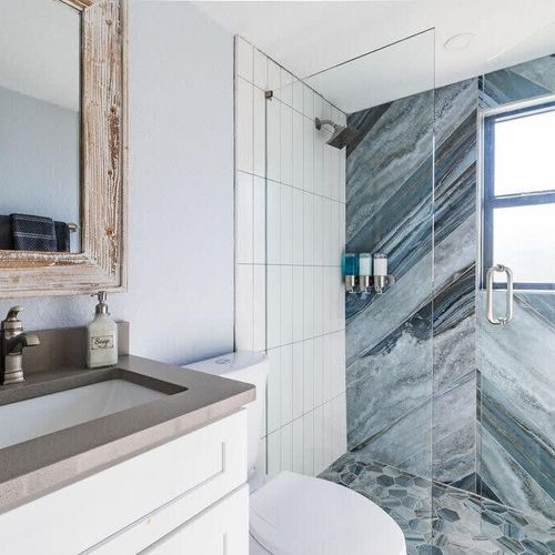 This bright and sleek bathroom offers a large, walk-in shower to refresh after a good night's sleep. If you're coming from the beach there's an outdoor shower to wash off the sand!