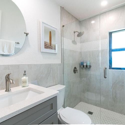 This bright and sleek bathroom offers a large, walk-in shower to refresh after a good night's sleep. If you're coming from the beach there's an outdoor shower to wash off the sand!