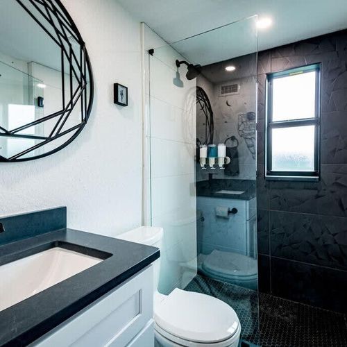 This bright and sleek bathroom offers a large, walk-in shower to refresh after a great night's sleep.