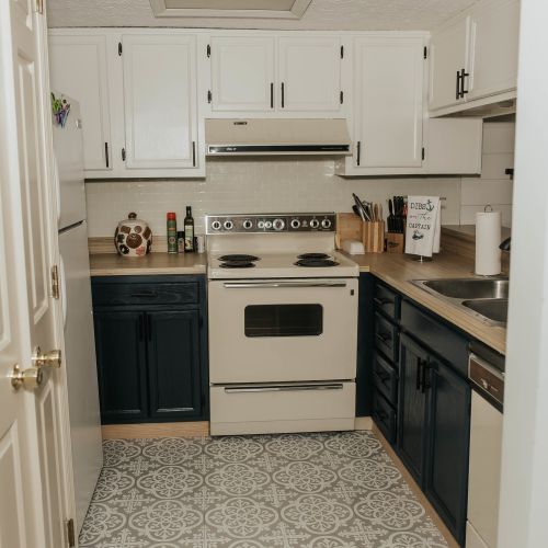 Spotless kitchen featuring a range, essential supplies, and utensils for all your cooking needs!