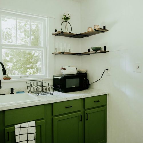 Experience the elegance of our white and green kitchen design, complete with all essential kitchen amenities.