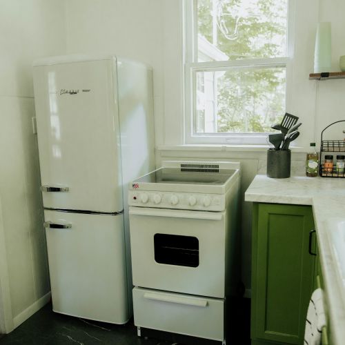 Complete with basic kitchen appliances including a refrigerator and range.