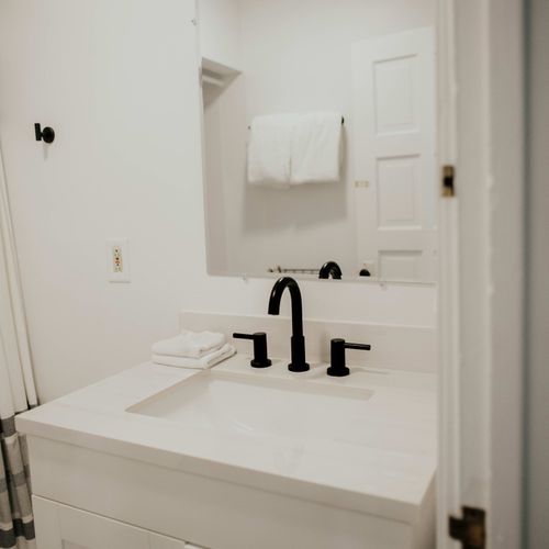 Experience our elegant, clean bathroom fully equipped with towels and essential bathroom amenities.