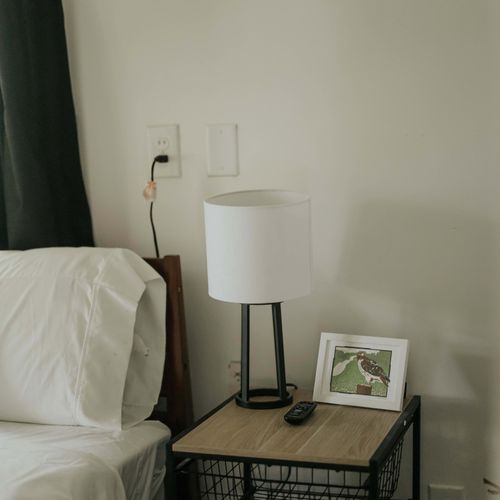 A stylish table and lamp setup for added convenience.