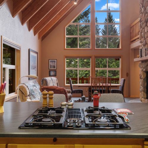 Cook with a view! This kitchen features a beautiful green landscape outside, adding a touch of tranquility to your culinary creations.