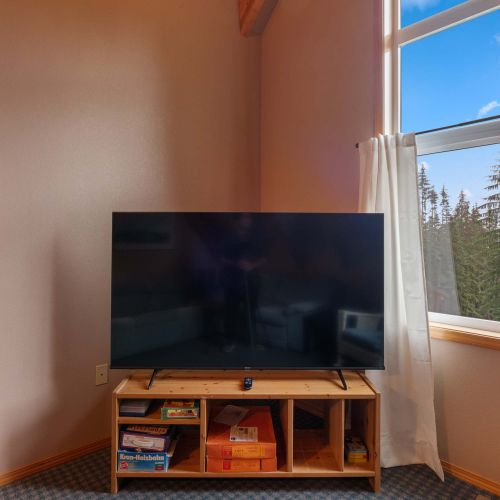 This TV is perfect for watching movies or shows, complemented by ambient lighting for a relaxed vibe.