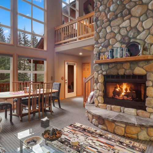 The open layout features a welcoming living room, a stylish dining room, and a gorgeous firepit that adds warmth and charm.