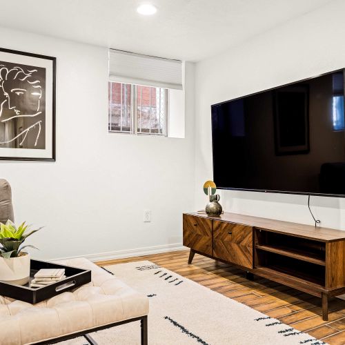 The basement living room has a Smart TV