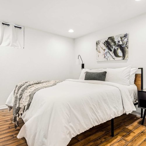 Bedroom 5 in the basement with queen bed