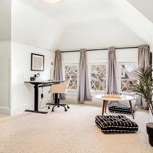 Bedroom 4 has a desk and chair as well as a seating area